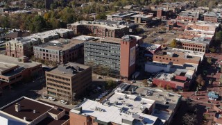 DX0001_001909 - 5.7K aerial stock footage approach a brick office building and ascend in Boulder, Colorado