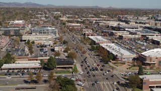DX0001_001951 - 5.7K aerial stock footage fly away from cars crossing an intersection in Boulder, Colorado