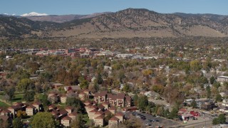 DX0001_001955 - 5.7K aerial stock footage of flying by the mountain town of Boulder, Colorado and then descending