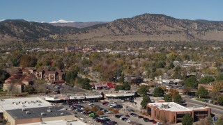 DX0001_001956 - 5.7K aerial stock footage of flying by the mountain town of Boulder, Colorado before descending