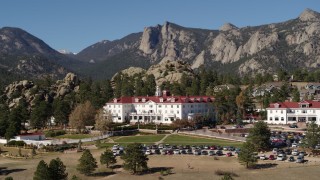 DX0001_001967 - 5.7K aerial stock footage ascend and pass the historic Stanley Hotel in Estes Park, Colorado