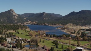 DX0001_001978 - 5.7K aerial stock footage of Lake Estes by golf course and green mountains in Estes Park, Colorado