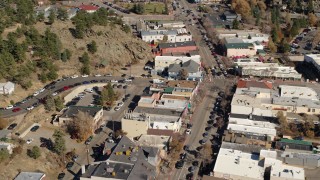 DX0001_001990 - 5.7K aerial stock footage slow reverse view of shops on road through Estes Park, Colorado