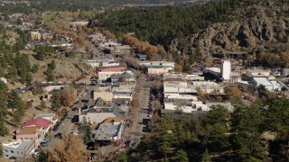 DX0001_001993 - 5.7K aerial stock footage ascend to stationary view of shops on road through Estes Park, Colorado