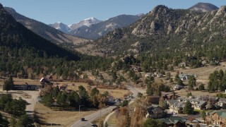 DX0001_002000 - 5.7K aerial stock footage of rural homes near rugged mountains in Estes Park, Colorado