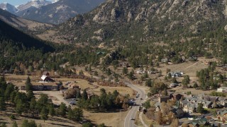 DX0001_002001 - 5.7K aerial stock footage of rural homes near rugged mountains in Estes Park, Colorado seen while descending