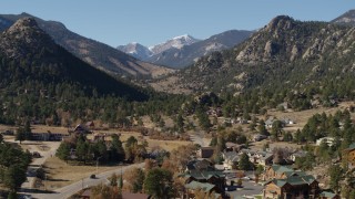 DX0001_002002 - 5.7K aerial stock footage of rural homes near rugged mountains in Estes Park, Colorado seen while ascending