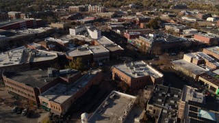 DX0001_002010 - 5.7K aerial stock footage of a reverse view of brick office buildings and shops in Fort Collins, Colorado