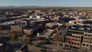 DX0001_002014 - 5.7K aerial stock footage passing by brick office buildings and shops in Fort Collins, Colorado