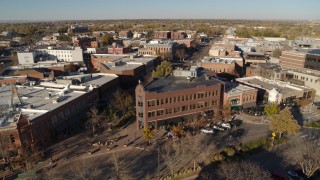 DX0001_002017 - 5.7K aerial stock footage slowly flyby a row of brick office buildings and shops in Fort Collins, Colorado