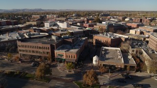 DX0001_002018 - 5.7K aerial stock footage slowly passing a row of brick office buildings and shops in Fort Collins, Colorado