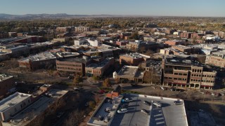 DX0001_002020 - 5.7K aerial stock footage approach a row of brick office buildings and focus on shops in Fort Collins, Colorado
