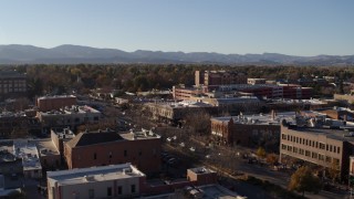 DX0001_002033 - 5.7K aerial stock footage flyby and away from a brick office buildings and shops in Fort Collins, Colorado