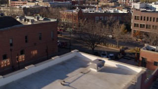 DX0001_002042 - 5.7K aerial stock footage of passing brick office buildings and street level shop in Fort Collins, Colorado