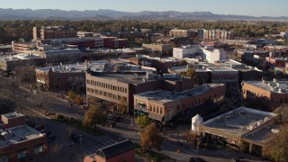DX0001_002045 - 5.7K aerial stock footage of passing brick office buildings and street level shops in Fort Collins, Colorado