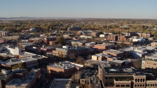 DX0001_002048 - 5.7K aerial stock footage of flying by several brick office buildings and street level shops in Fort Collins, Colorado