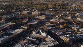 DX0001_002052 - 5.7K aerial stock footage of shops and office buildings in foreground near apartment buildings in Fort Collins, Colorado