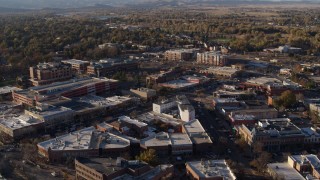 DX0001_002055 - 5.7K aerial stock footage fly away from and flyby shops and office buildings by wide streets in Fort Collins, Colorado
