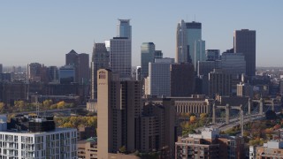 DX0001_002107 - 5.7K aerial stock footage of city's skyline seen from condo complex, reveal apartments at sunrise in Downtown Minneapolis, Minnesota