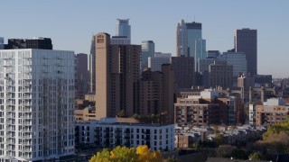 DX0001_002108 - 5.7K aerial stock footage flyby apartments to reveal condo complex and city's skyline at sunrise in Downtown Minneapolis, Minnesota