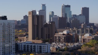 DX0001_002111 - 5.7K aerial stock footage descend near condo complex with view of city's skyline at sunrise in Downtown Minneapolis, Minnesota