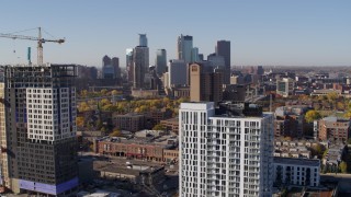 DX0001_002114 - 5.7K aerial stock footage of a view of the city's skyline seen from apartment building at sunrise in Downtown Minneapolis, Minnesota