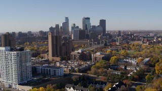 DX0001_002115 - 5.7K aerial stock footage of the city's skyline seen from apartment building at sunrise in Downtown Minneapolis, Minnesota