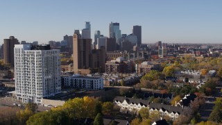 DX0001_002119 - 5.7K aerial stock footage of flyby apartment building at sunrise, condo complex and skyline in background in Downtown Minneapolis, Minnesota