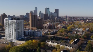 DX0001_002122 - 5.7K aerial stock footage ascend by apartment complex for view of skyline in Downtown Minneapolis, Minnesota