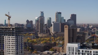 DX0001_002126 - 5.7K aerial stock footage descend and flyby residential buildings with view of skyline at sunrise in Downtown Minneapolis, Minnesota