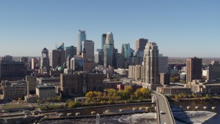 DX0001_002136 - 5.7K aerial stock footage slowly flying by the skyline, seen from a bridge spanning the river in Downtown Minneapolis, Minnesota