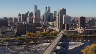 DX0001_002137 - 5.7K aerial stock footage slowly passing by the skyline, seen from a bridge spanning the river in Downtown Minneapolis, Minnesota