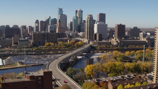 DX0001_002148 - 5.7K aerial stock footage descend near a bridge spanning the river with view of the skyline, Downtown Minneapolis, Minnesota