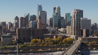 DX0001_002149 - 5.7K aerial stock footage flying by the skyline on the other side of the Mississippi River, Downtown Minneapolis, Minnesota