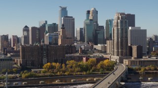 DX0001_002150 - 5.7K aerial stock footage passing by the skyline on the other side of the Mississippi River, Downtown Minneapolis, Minnesota