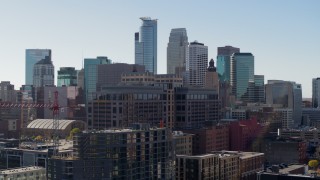 DX0001_002157 - 5.7K aerial stock footage flying by office building with view of the city's skyline during ascent, Downtown Minneapolis, Minnesota