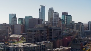 DX0001_002159 - 5.7K aerial stock footage passing by office building and city's skyline, Downtown Minneapolis, Minnesota