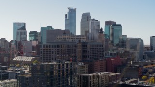 DX0001_002161 - 5.7K aerial stock footage descend near office building and city's skyline, Downtown Minneapolis, Minnesota