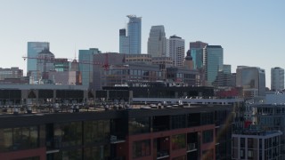 DX0001_002165 - 5.7K aerial stock footage descend by office building and city's skyline, reveal apartment building, Downtown Minneapolis, Minnesota