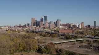 DX0001_002171 - 5.7K aerial stock footage a view of the city skyline while flying away from freeway, Downtown Minneapolis, Minnesota