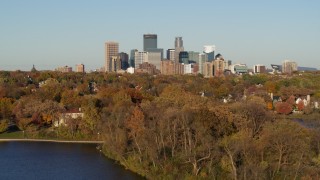 DX0001_002194 - 5.7K aerial stock footage ascend from lake to wide view of the city's skyline, Downtown Minneapolis, Minnesota