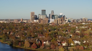 DX0001_002195 - 5.7K aerial stock footage a wide view of the city's skyline seen from homes by the lake, Downtown Minneapolis, Minnesota