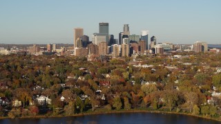 DX0001_002196 - 5.7K aerial stock footage a wide view of the city's skyline seen from houses by the lake, Downtown Minneapolis, Minnesota