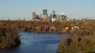 DX0001_002198 - 5.7K aerial stock footage ascend from Lake of the Isles for a view of the downtown skyline, Downtown Minneapolis, Minnesota
