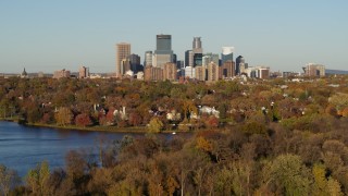 DX0001_002199 - 5.7K aerial stock footage descend toward Lake of the Isles with a view of the downtown skyline, Downtown Minneapolis, Minnesota