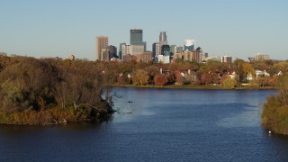 DX0001_002201 - 5.7K aerial stock footage of the downtown skyline seen from homes by Lake of the Isles, Downtown Minneapolis, Minnesota