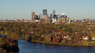 DX0001_002202 - 5.7K aerial stock footage of the downtown skyline seen from waterfront homes by Lake of the Isles, Downtown Minneapolis, Minnesota