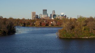 DX0001_002203 - 5.7K aerial stock footage of the downtown skyline seen from Lake of the Isles, Downtown Minneapolis, Minnesota