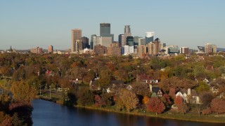 DX0001_002205 - 5.7K aerial stock footage of the city skyline, seen from lakeside homes, Downtown Minneapolis, Minnesota