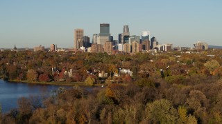 DX0001_002207 - 5.7K aerial stock footage ascend from Lake of the Isles for wide view of the skyline of Downtown Minneapolis, Minnesota